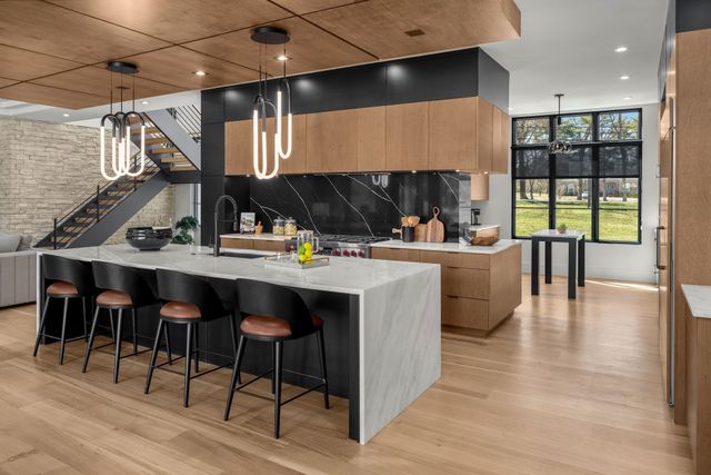 a dining room with wooden floor and stainless steel appliances