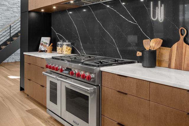 a living room with furniture pool table and a large window