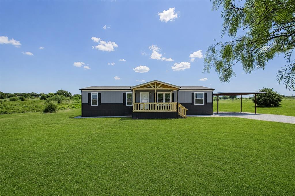 2008 Buffet Way Poolville, TX 76487 - Photo 5 of 40 a front view of a house with a garden