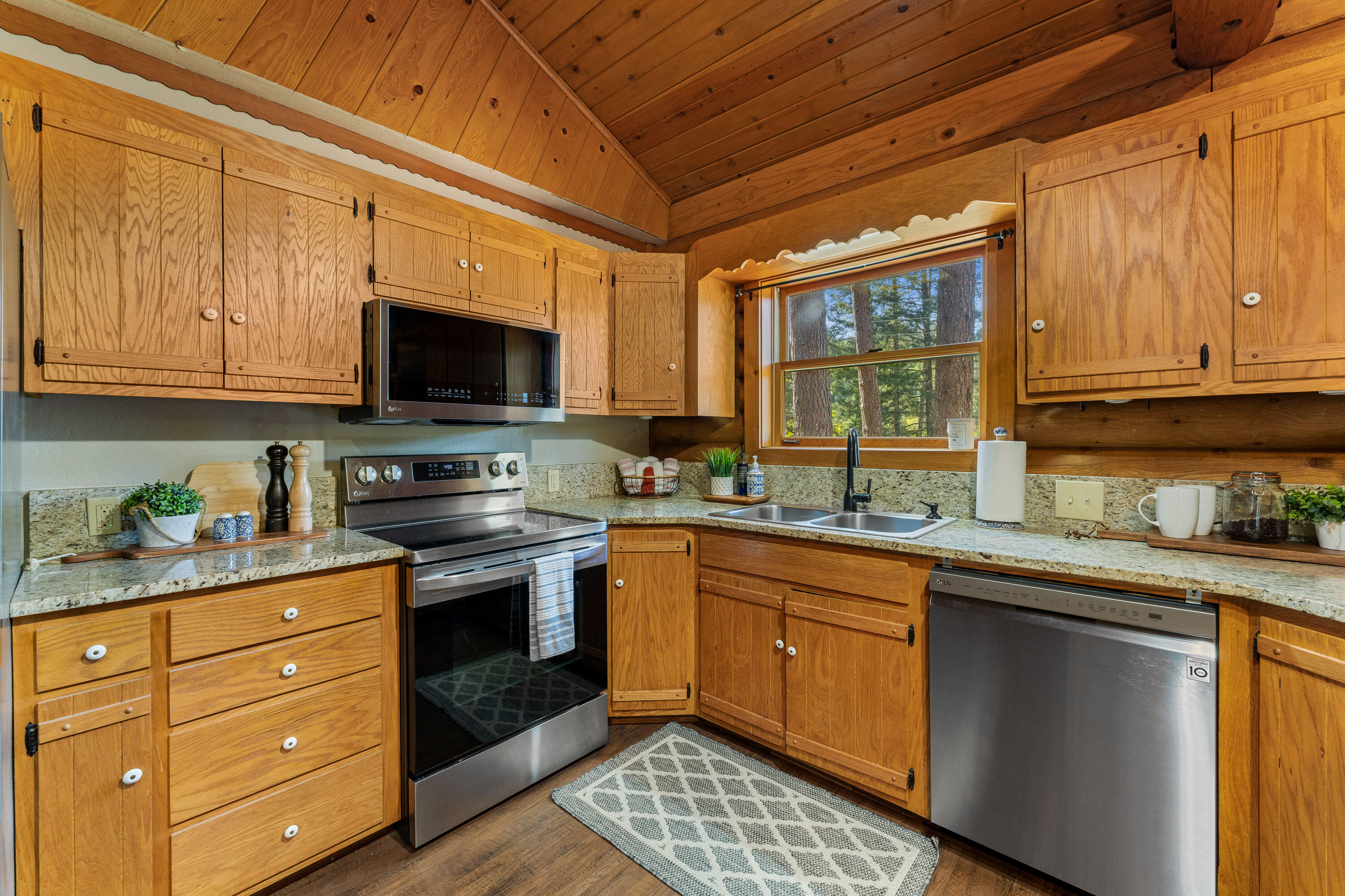 1201 Reeves Creek Road Selma, OR 97538 - Photo 13 of 38 a kitchen with stainless steel appliances granite countertop a stove sink and cabinets