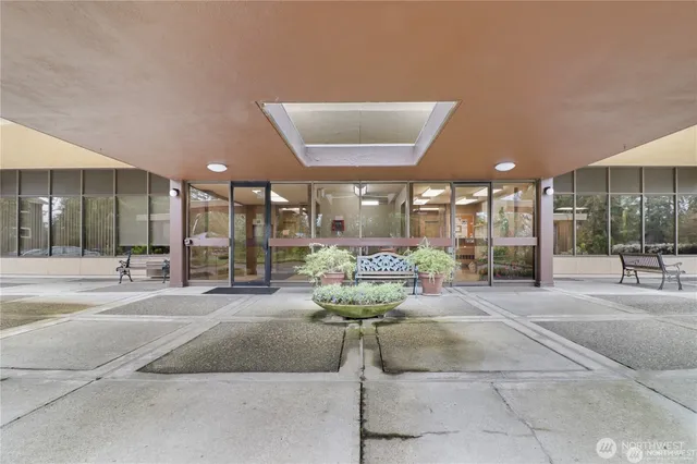 a lobby with furniture and large windows