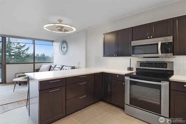a kitchen with a sink stove and microwave