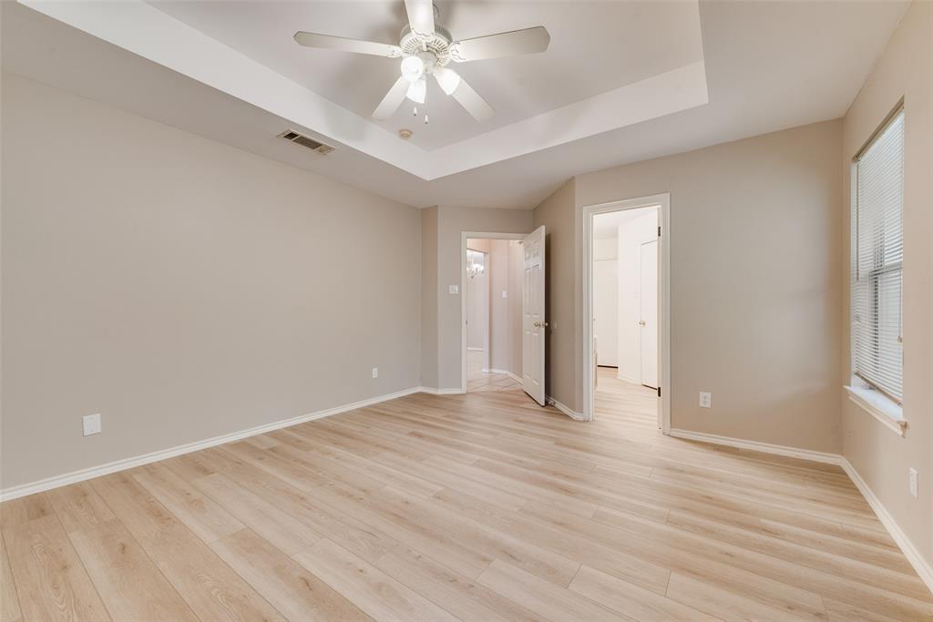 225 Juniper Ridge Court DeSoto, TX 75115 - Photo 11 of 17 wooden floor in an empty room with a window