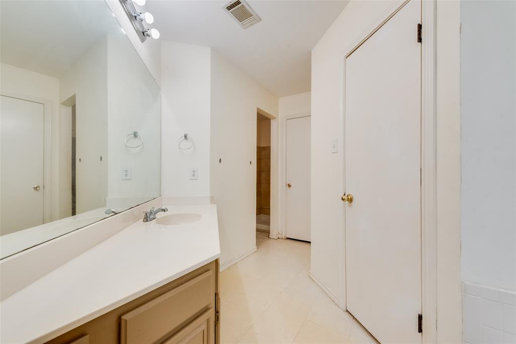 225 Juniper Ridge Court DeSoto, TX 75115 - Photo 13 of 17 a bathroom with a sink and a mirror