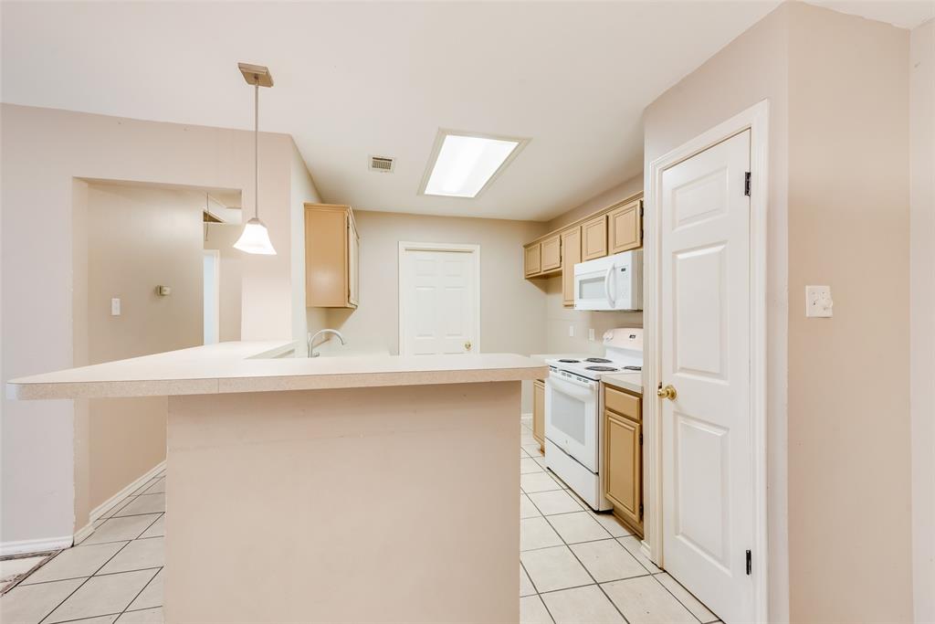 225 Juniper Ridge Court DeSoto, TX 75115 - Photo 8 of 17 a kitchen with stainless steel appliances a stove sink and refrigerator