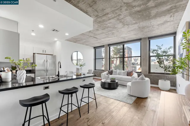 a large living room with a large window and furniture