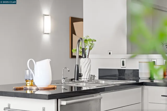 a kitchen with a sink a counter and cabinets