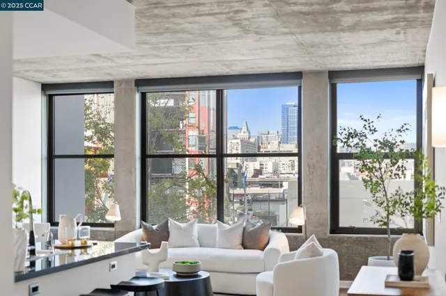 a living room with furniture and large windows