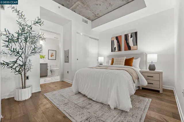 a bedroom with bed and wooden floor