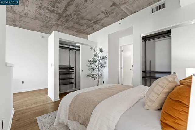 a bedroom with a bed and a flat tv screen