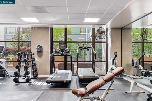 a room with gym equipment and a large window