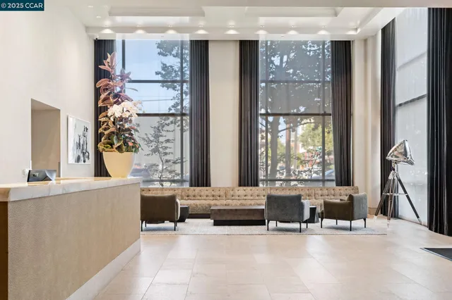 a living room with furniture and large windows