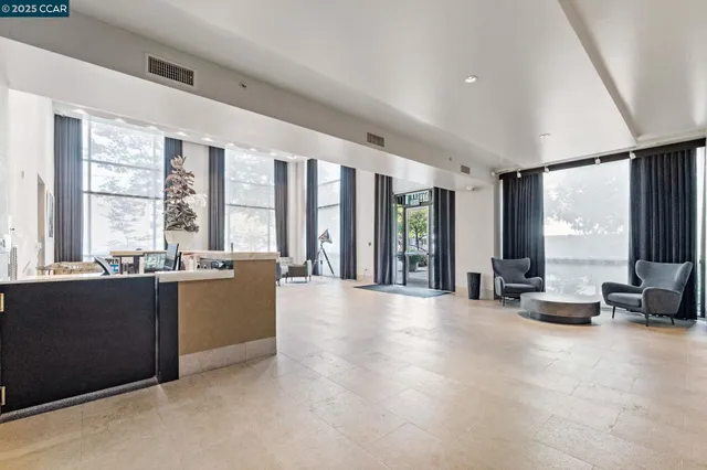 a large living room with furniture and large windows