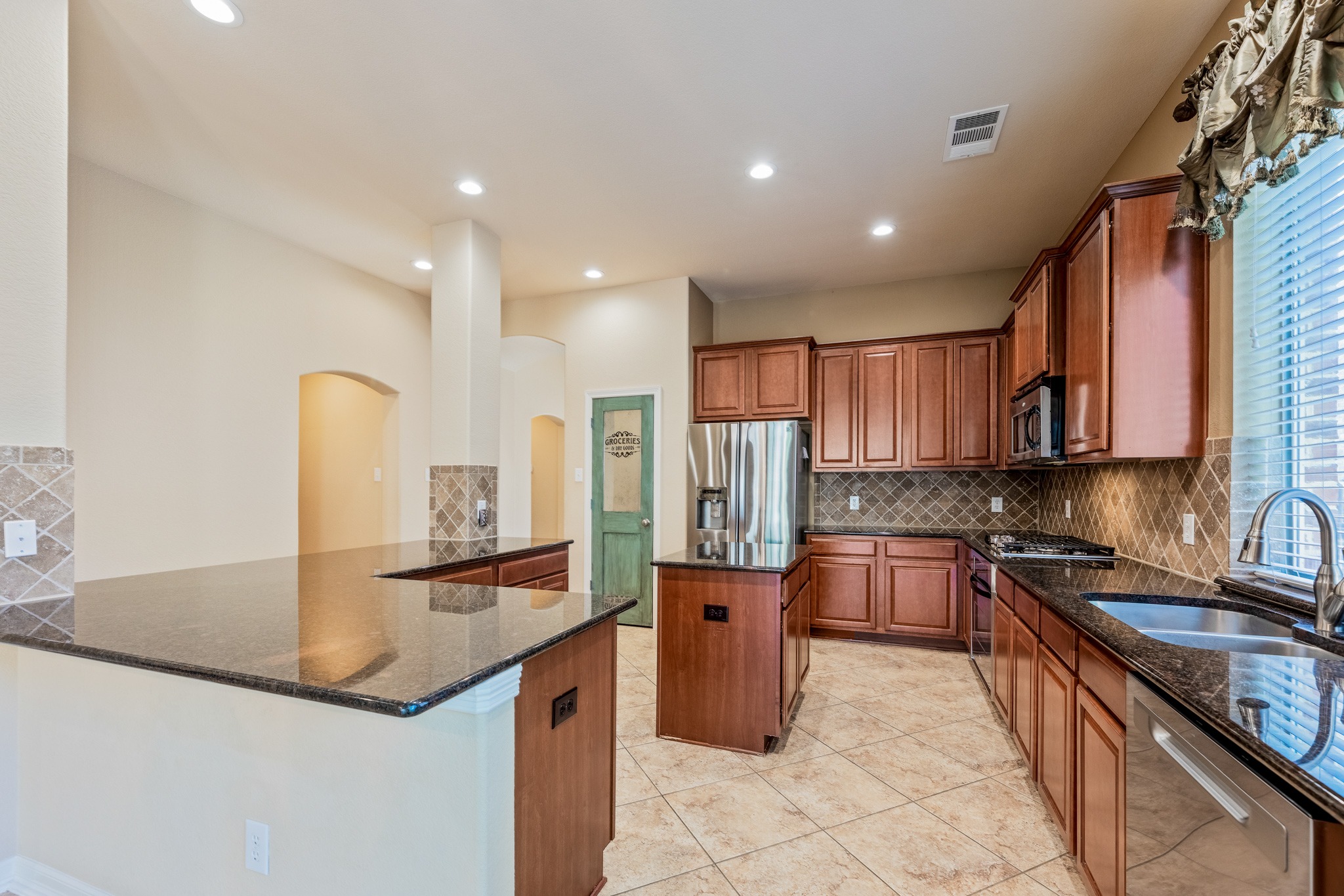 20804 Windmill Ridge Street Pflugerville, TX 78660 - Photo 3 of 40 A bright and spacious kitchen with dining area serves as the heart of the home, overlooking the living room.