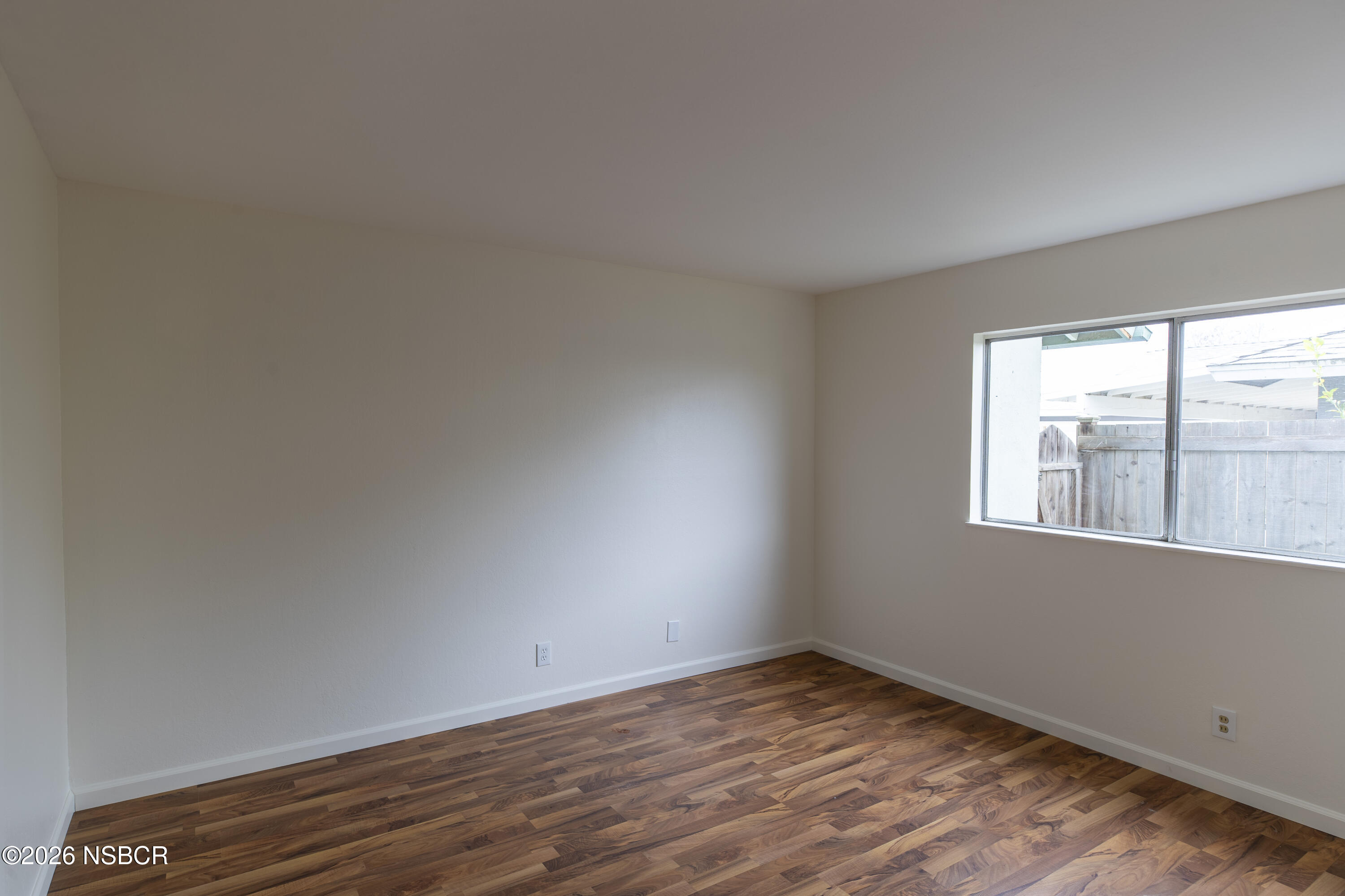 901 Alden Avenue Lompoc, CA 93436 - Photo 20 of 42 an empty room with wooden floor and windows