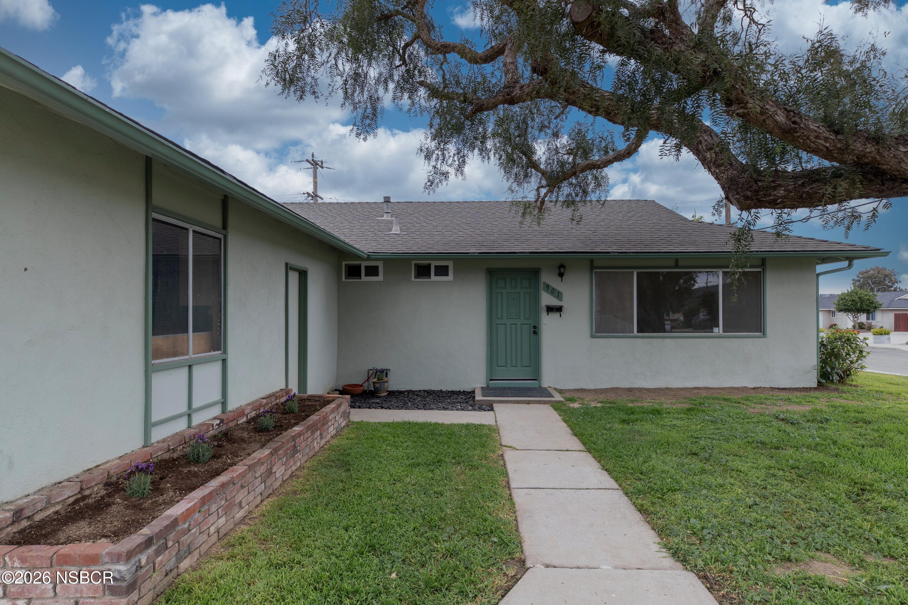 901 Alden Avenue Lompoc, CA 93436 - Photo 2 of 42 a front view of a house with a garden