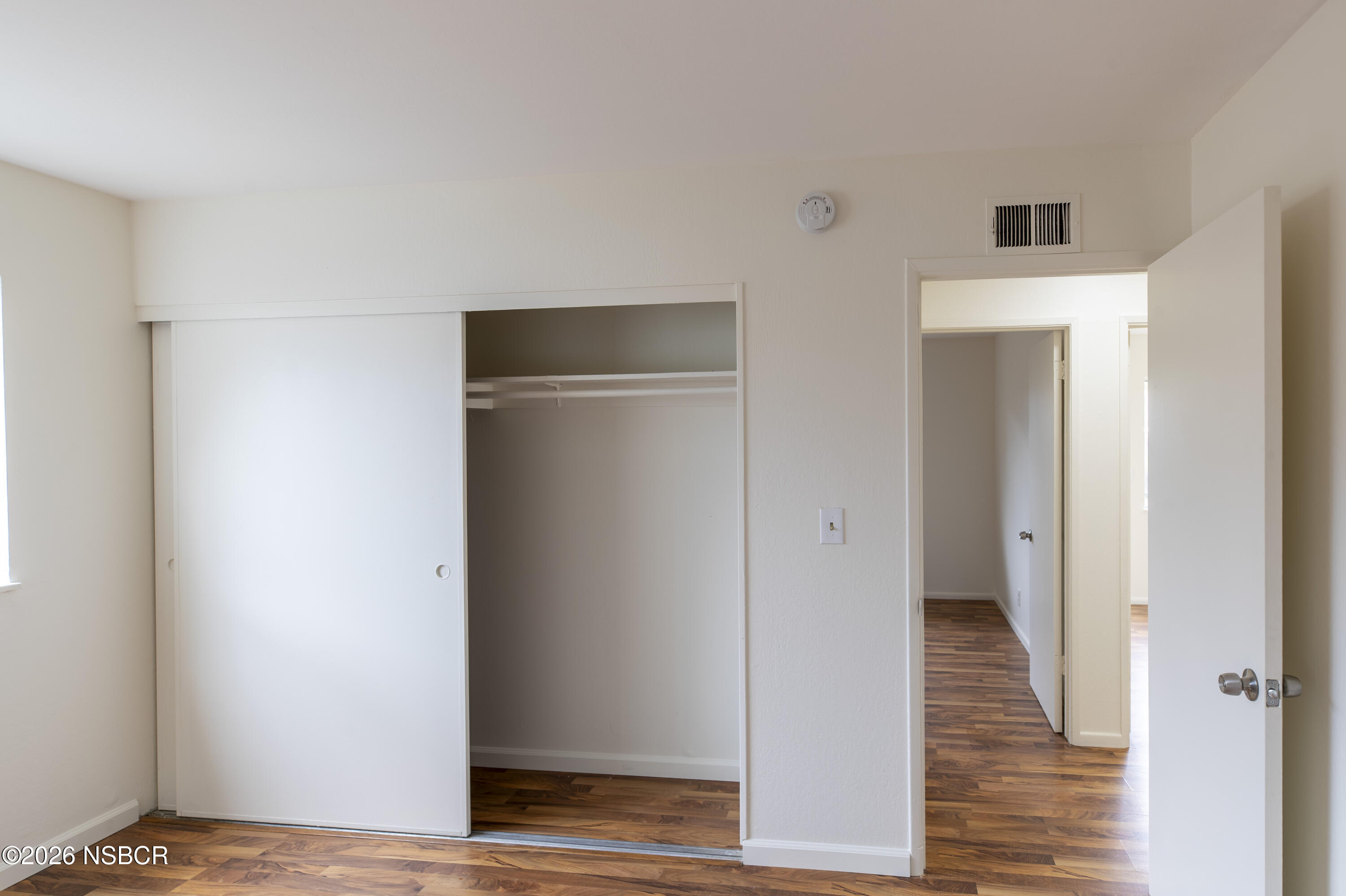 901 Alden Avenue Lompoc, CA 93436 - Photo 22 of 42 a view of a hallway with wooden floor and closet