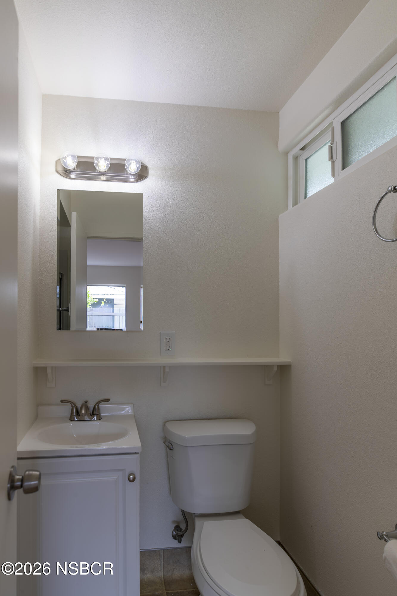 901 Alden Avenue Lompoc, CA 93436 - Photo 23 of 42 a bathroom with a toilet a sink and mirror
