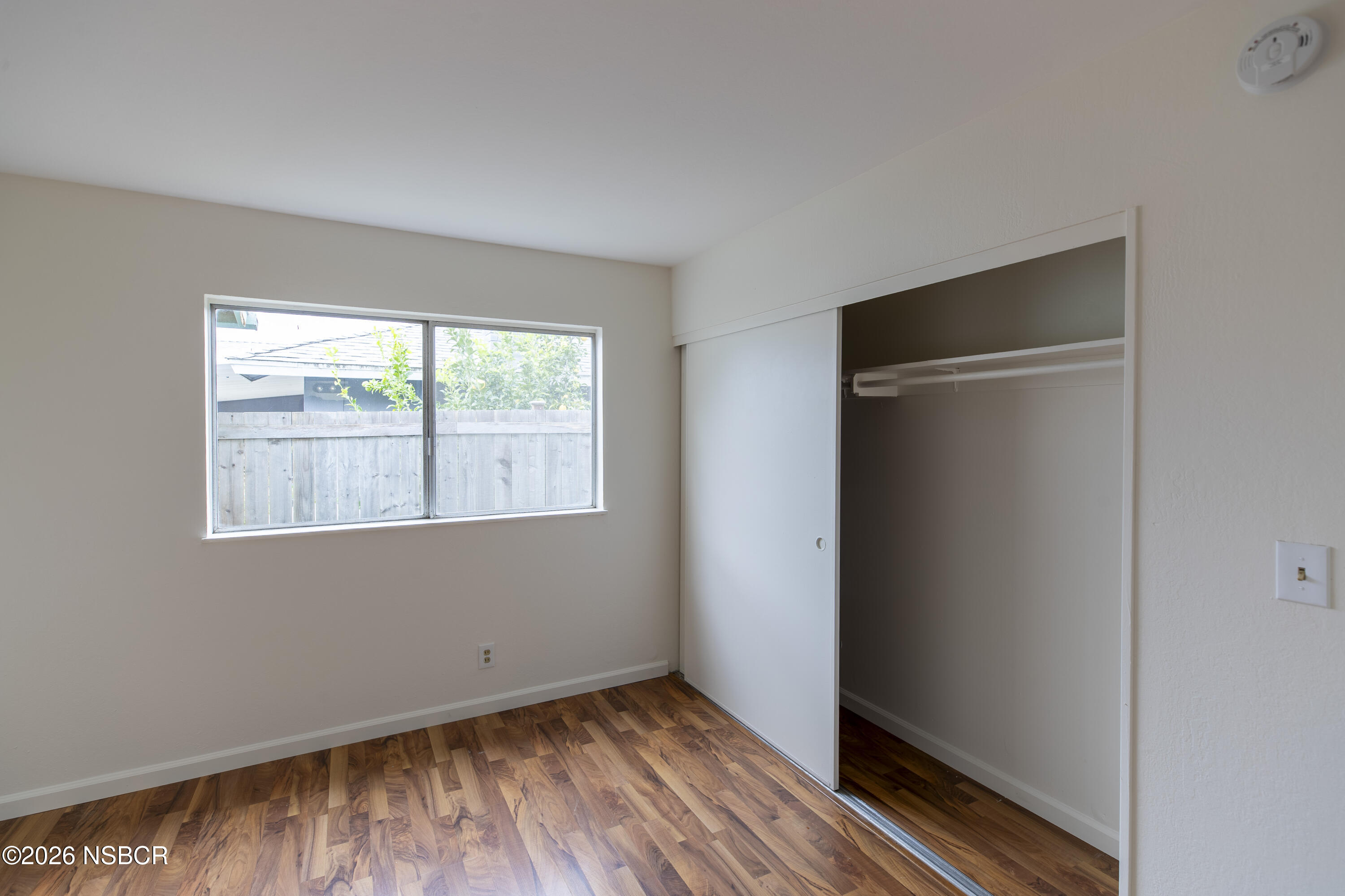 901 Alden Avenue Lompoc, CA 93436 - Photo 25 of 42 a view of an empty room with wooden floor and a window