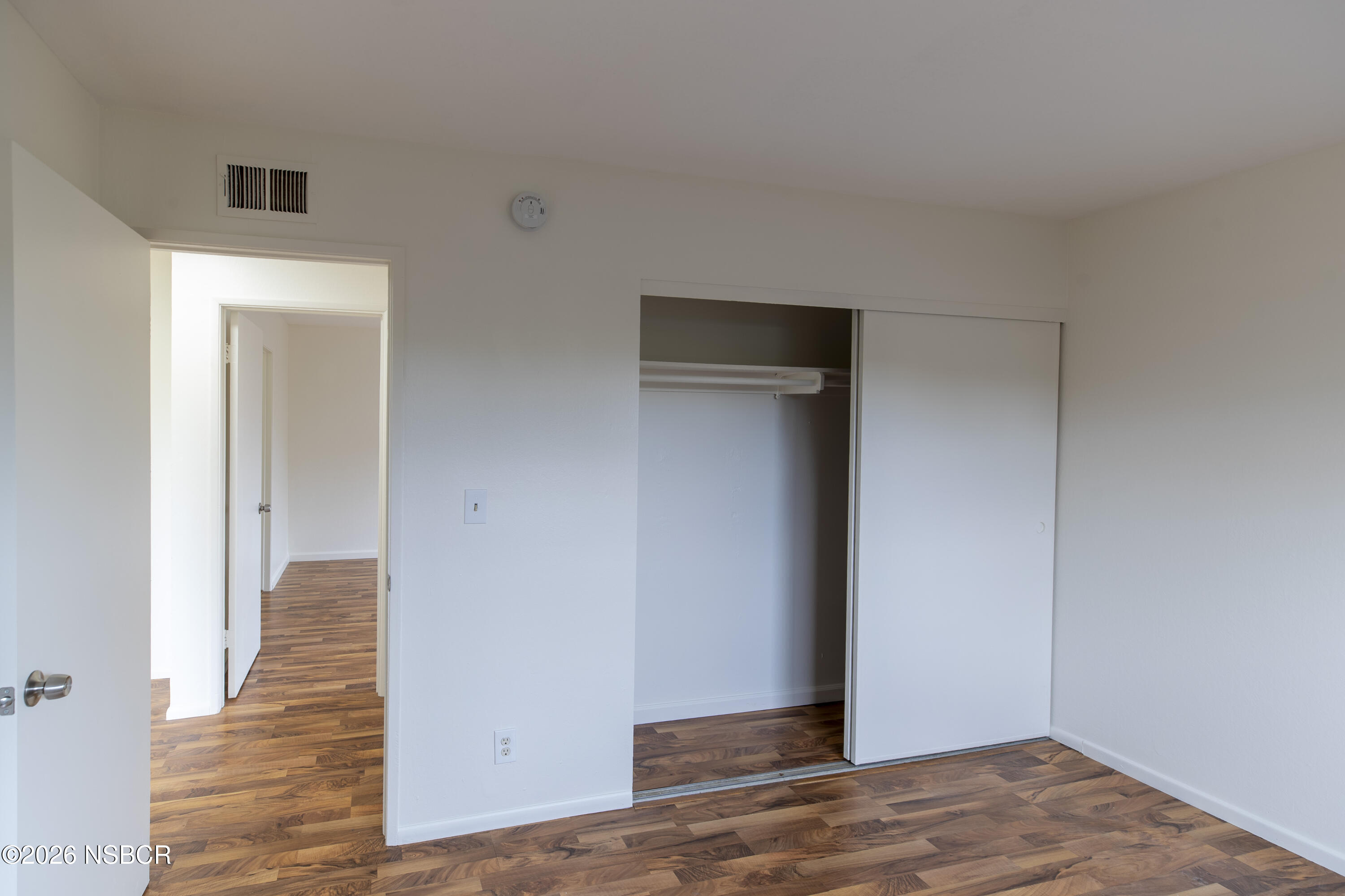 901 Alden Avenue Lompoc, CA 93436 - Photo 27 of 42 a view of a hallway with wooden floor and closet