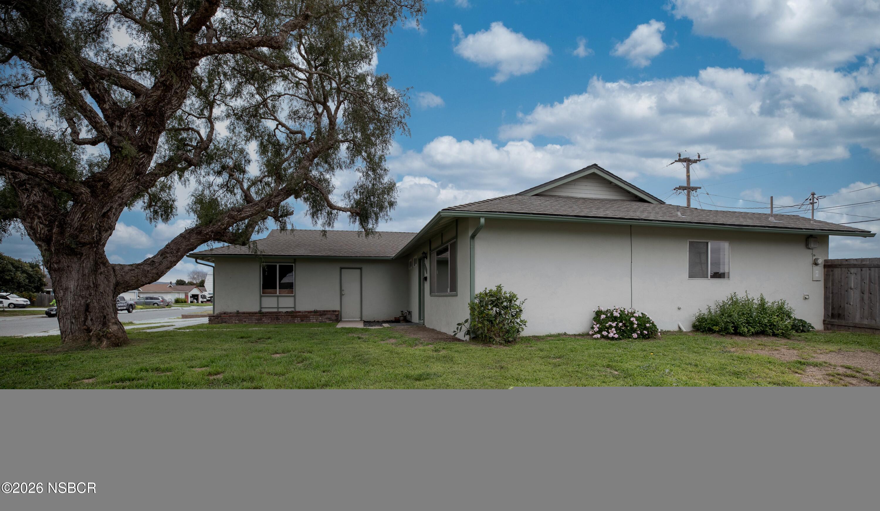 901 Alden Avenue Lompoc, CA 93436 - Photo 38 of 42 a view of a yard in front of a house with a large tree