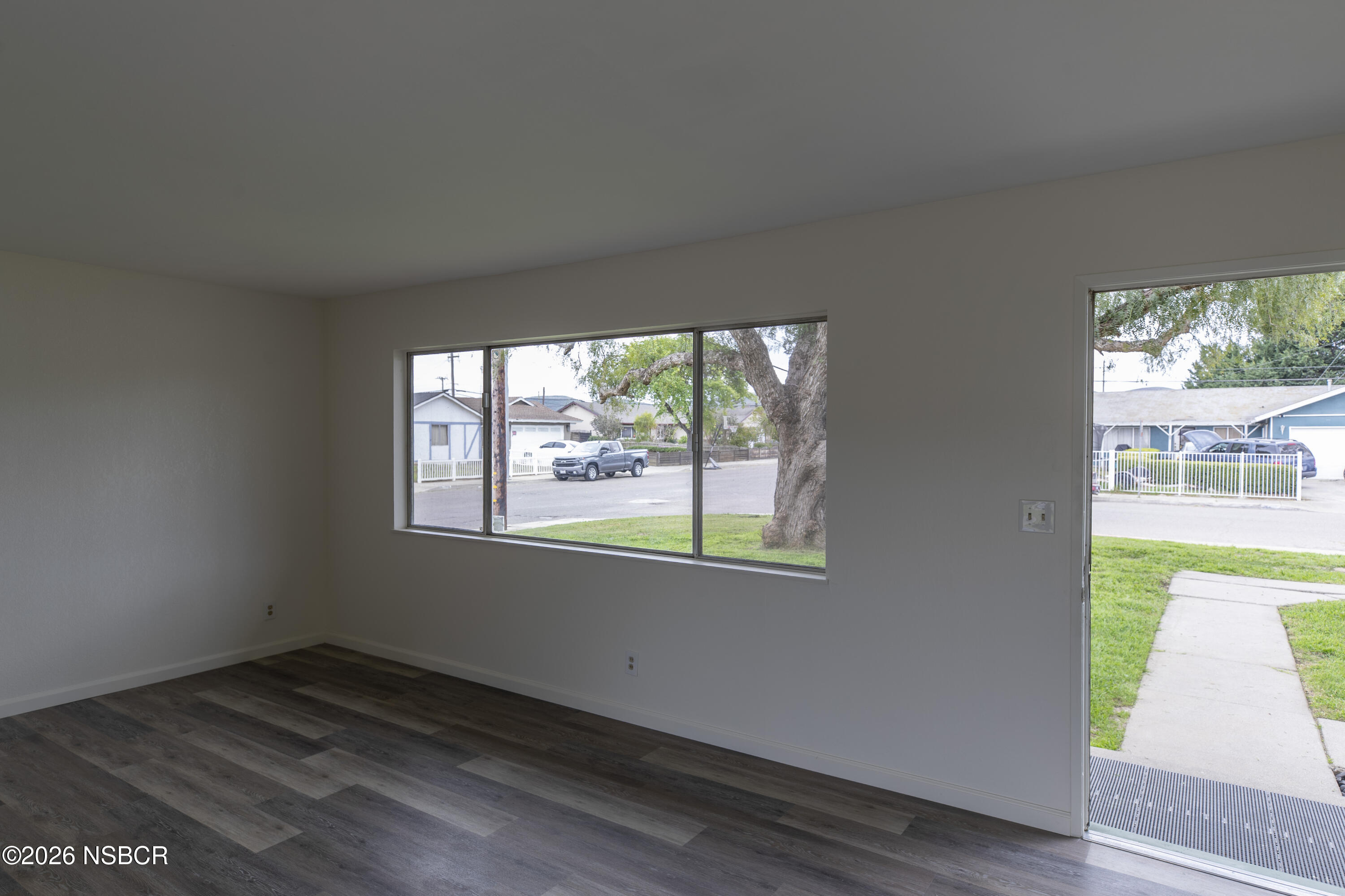 901 Alden Avenue Lompoc, CA 93436 - Photo 4 of 42 an empty room with wooden floor and windows