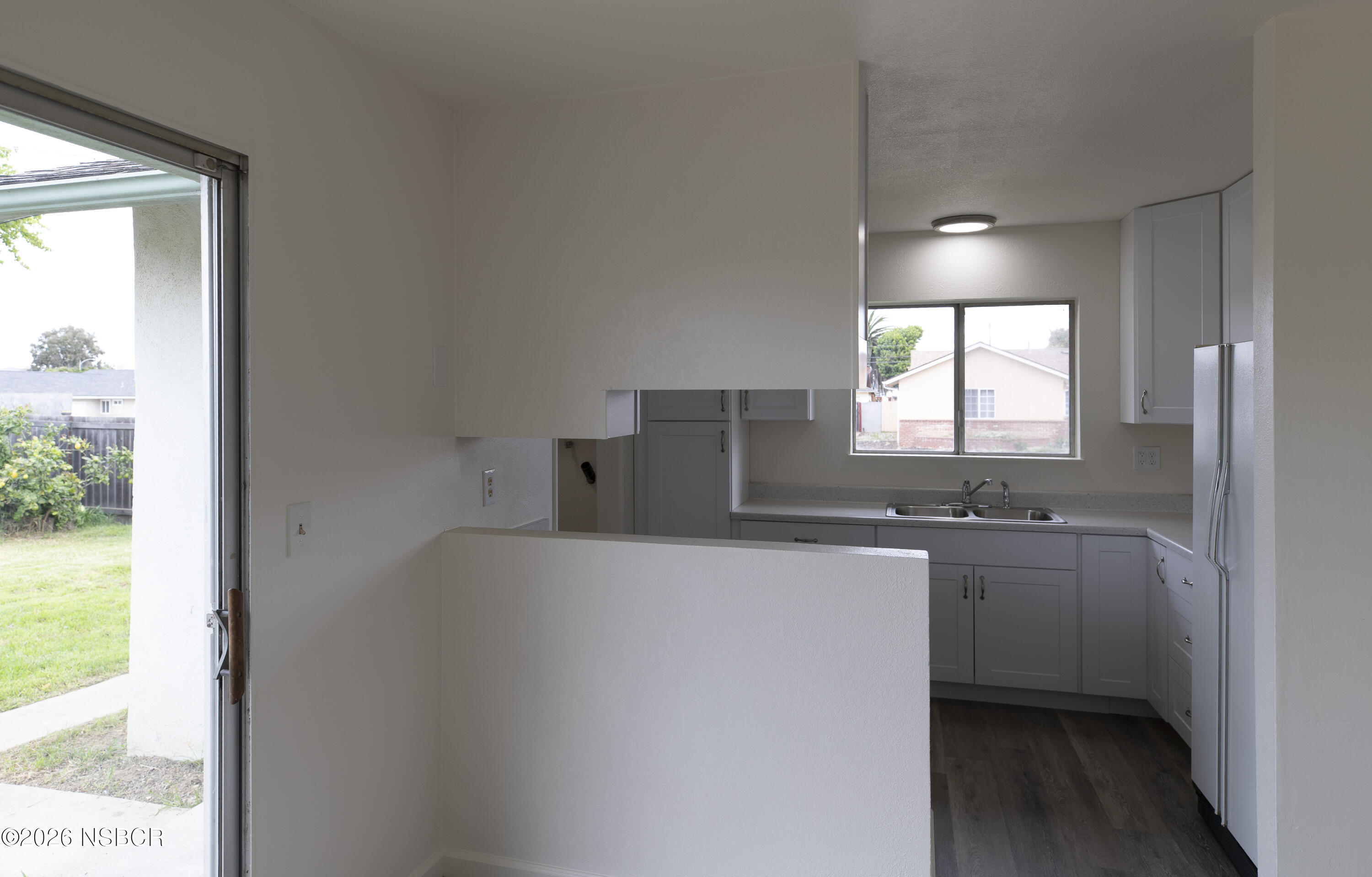 901 Alden Avenue Lompoc, CA 93436 - Photo 6 of 42 a kitchen with stainless steel appliances a sink a stove a refrigerator a window and a counter top space