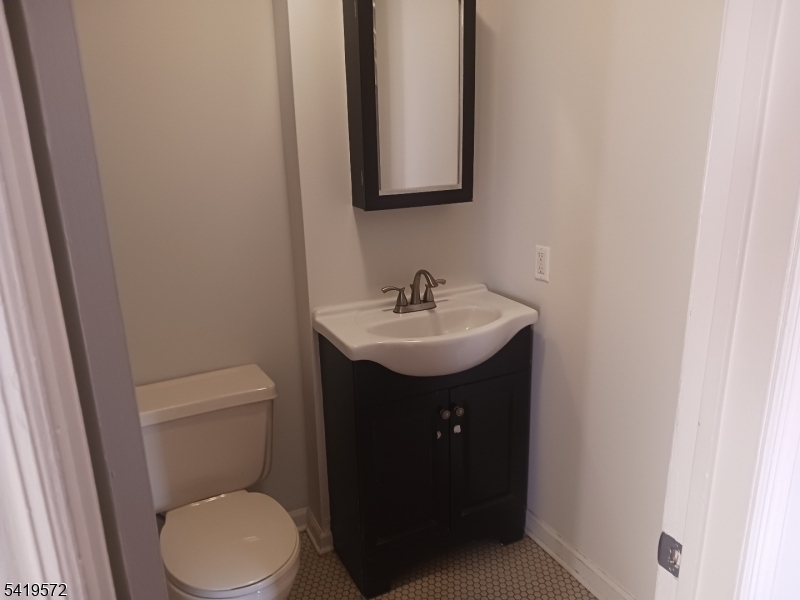 83 North Willow Street, Unit 1 Montclair, NJ 07042 - Photo 6 of 8 a bathroom with a sink toilet and mirror