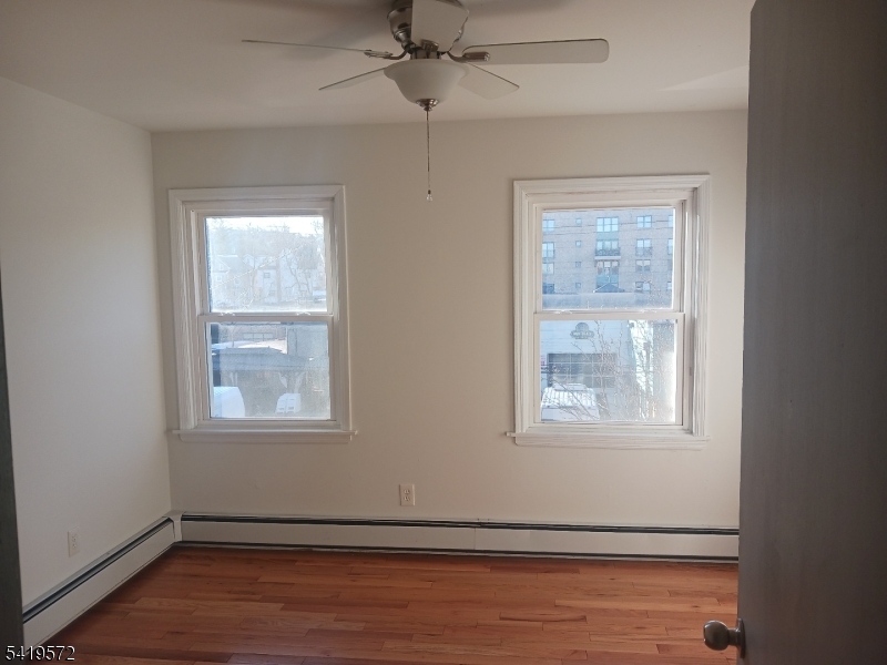 83 North Willow Street, Unit 1 Montclair, NJ 07042 - Photo 7 of 8 an empty room with wooden floor and windows