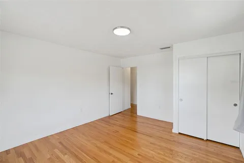 a bedroom with a large bed and a window