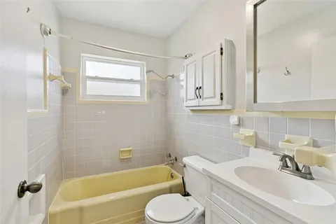 a bathroom with a sink a toilet and mirror