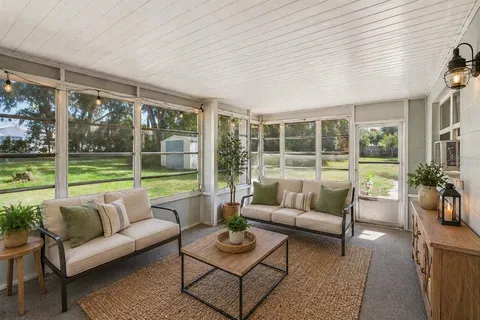 an aerial view of a house with garden space and street view