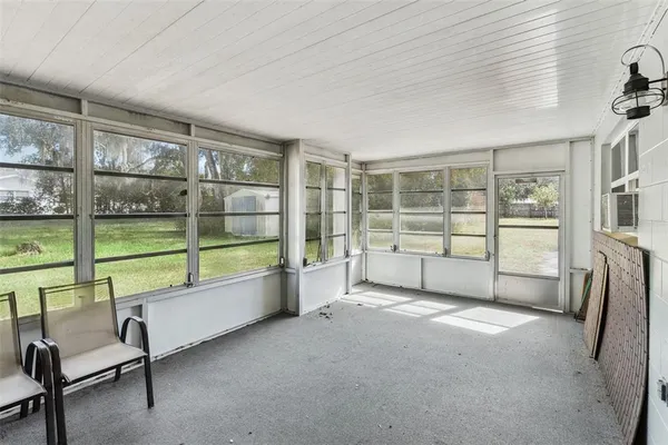a living room with a large window and a balcony