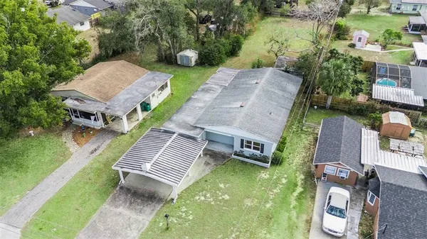an aerial view of a house with garden space and street view
