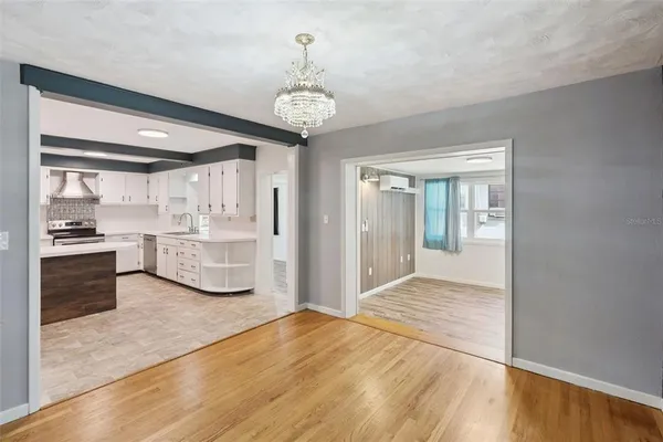 a view of kitchen with granite countertop cabinets and refrigerator