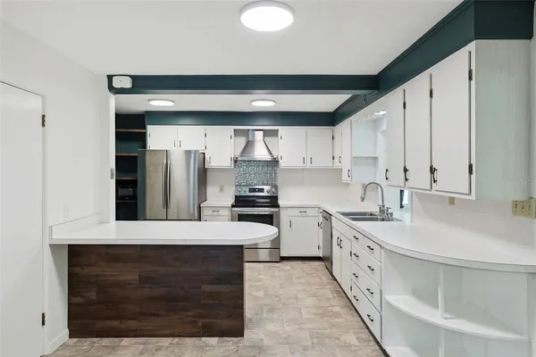 a large kitchen with kitchen island a sink stainless steel appliances and cabinets