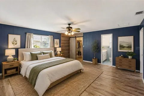 a view of a room with a chandelier fan and windows