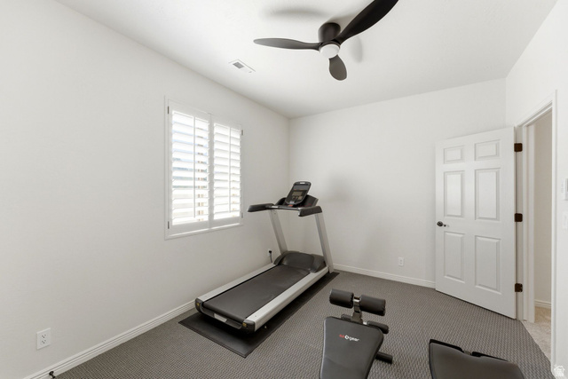 1712 Somerset Ridge Drive Draper, UT 84020 - Photo 67 of 76 Interior room featuring white walls, a single window with white plantation shutters, and a dark ceiling fan with three blades