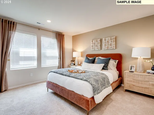 a bedroom with a bed lamp and window