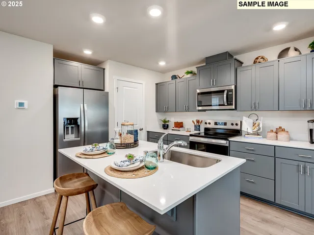 a kitchen with refrigerator cabinets and wooden floor