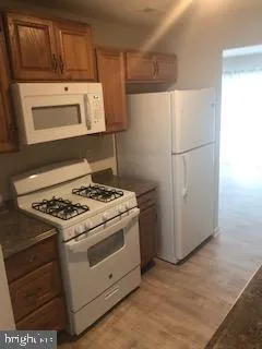 a stove top oven sitting inside of a kitchen