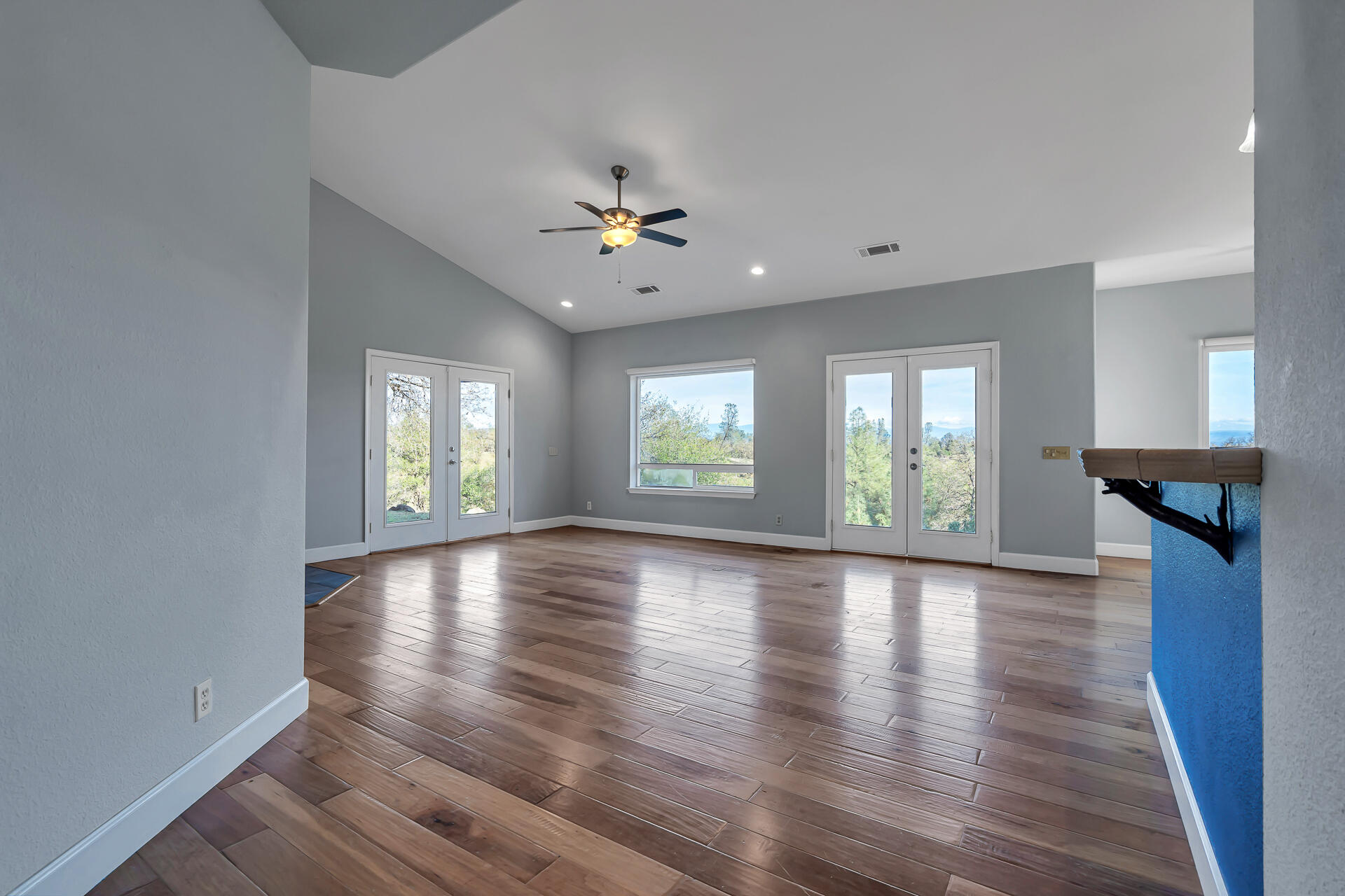 13303 Intermountain Road Redding, CA 96003 - Photo 26 of 64 an empty room with wooden floor and windows