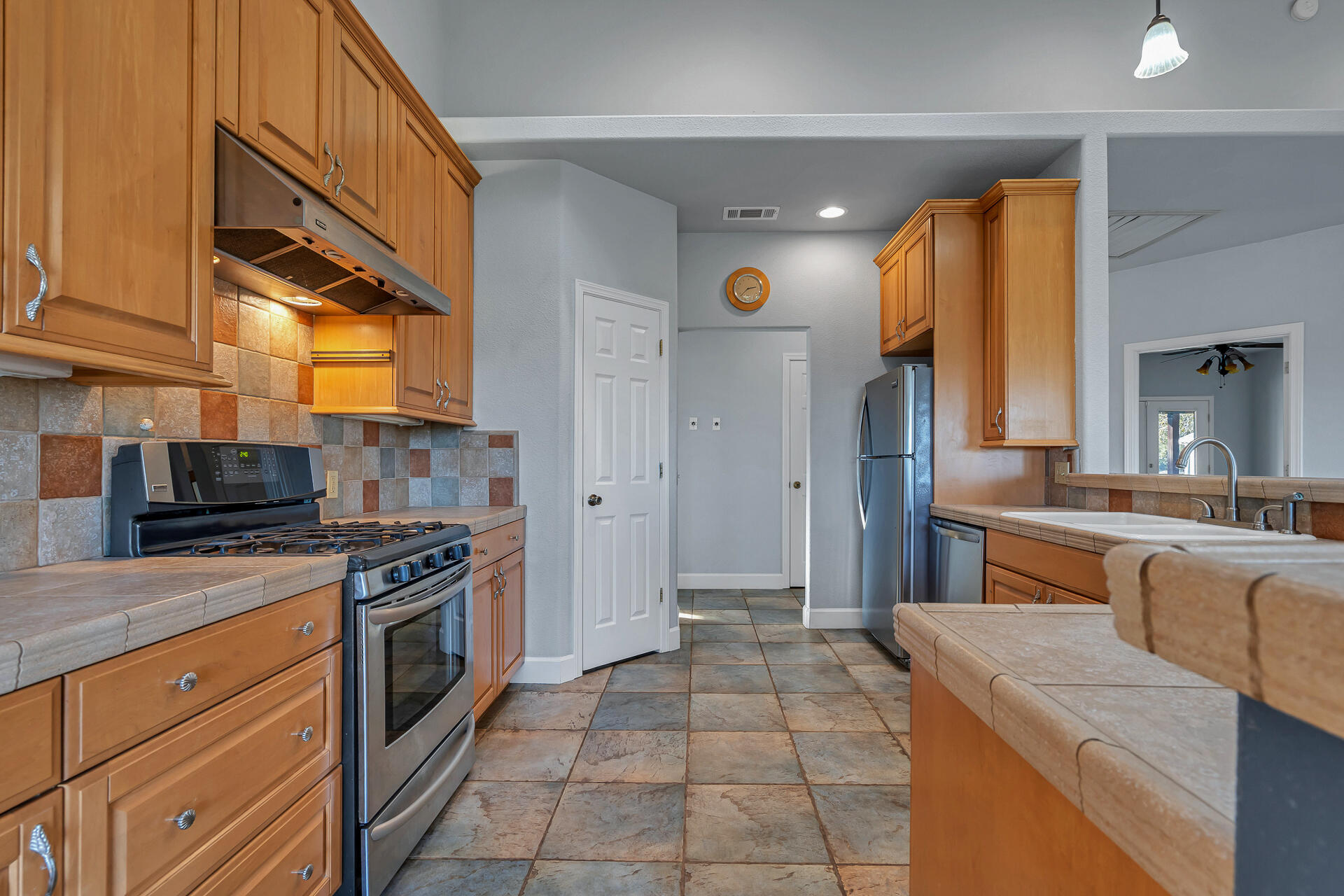 13303 Intermountain Road Redding, CA 96003 - Photo 37 of 64 a kitchen with stainless steel appliances granite countertop a stove a sink and a refrigerator