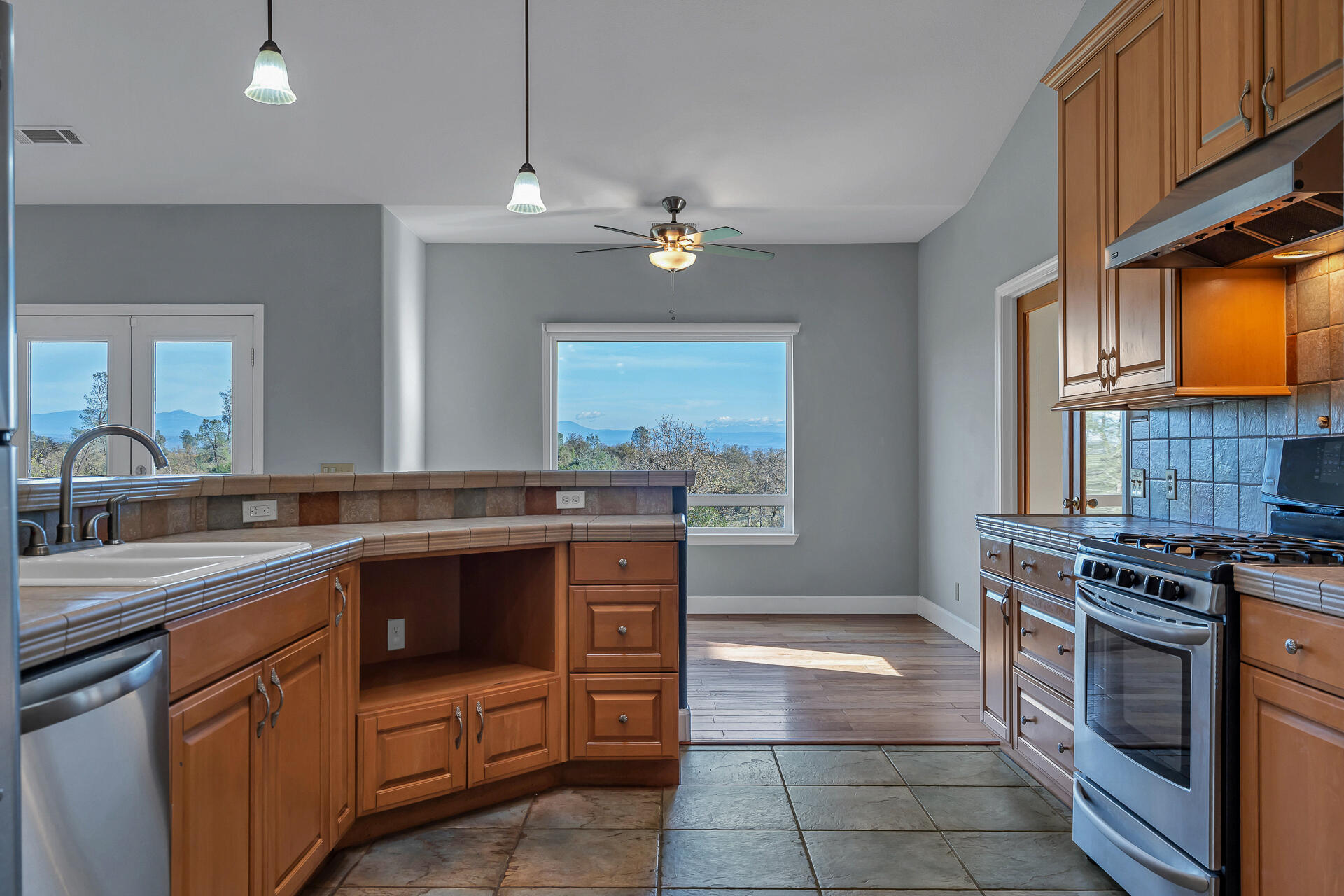 13303 Intermountain Road Redding, CA 96003 - Photo 40 of 64 a kitchen with a stove sink and cabinets