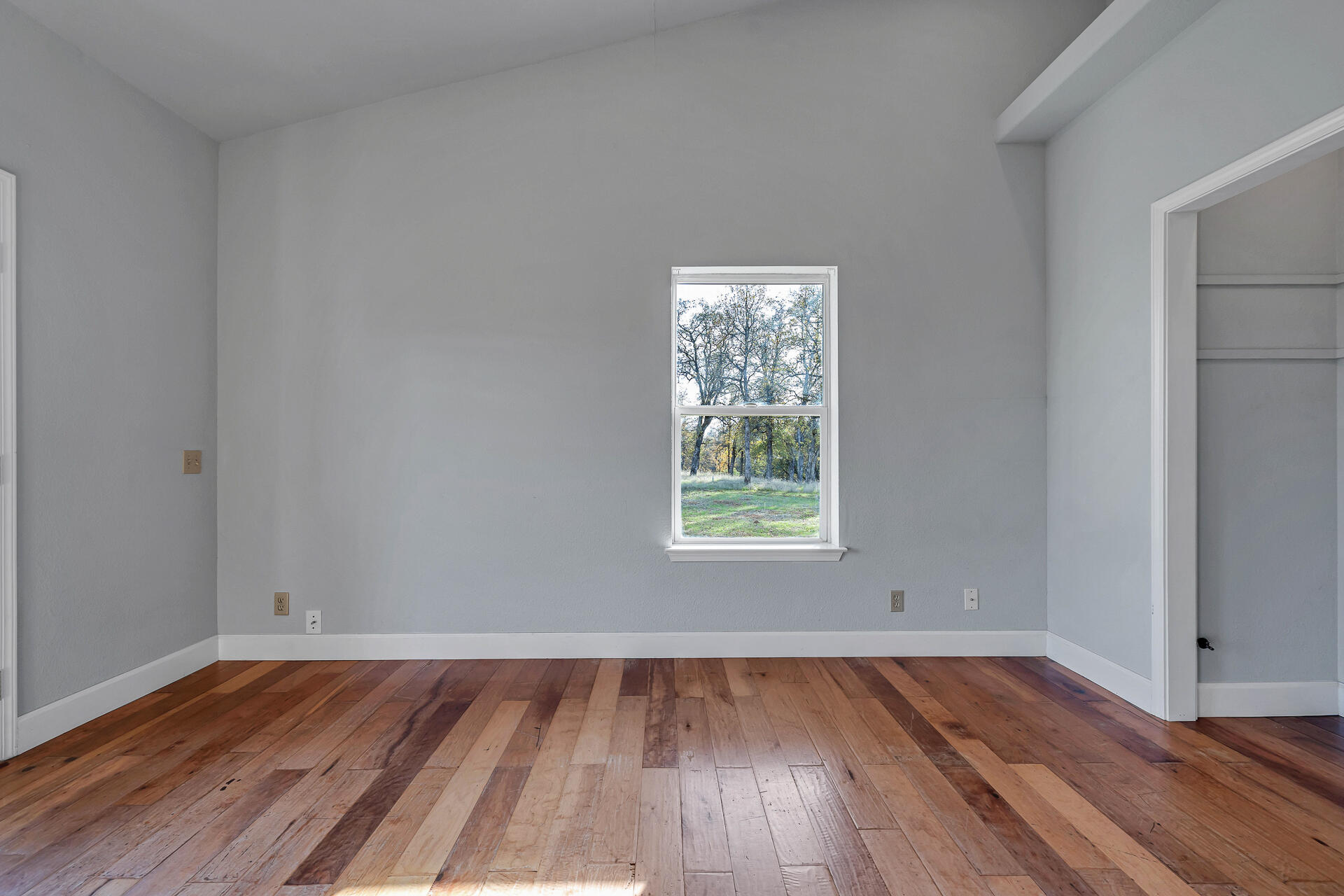 13303 Intermountain Road Redding, CA 96003 - Photo 57 of 64 an empty room with wooden floor and windows