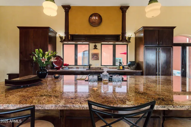 a spacious bedroom with a bed a couch and a chandelier