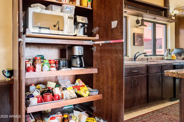 a view of a hallway with wooden floor and entryway