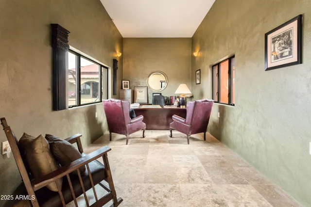 a living room with furniture a large window and a flat screen tv