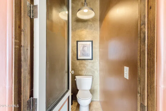 a view of a hallway with furniture and floor to ceiling window