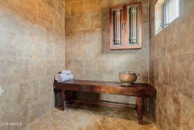 a living room with furniture and a mirror